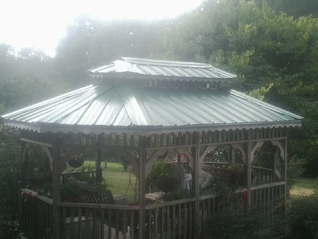 Two tier green metal roof on a garden gazebo in Coral